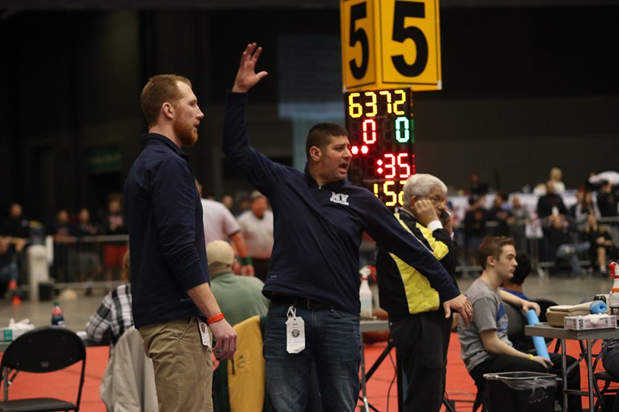 Coach Keal yells during Senior Jett Bendures match.