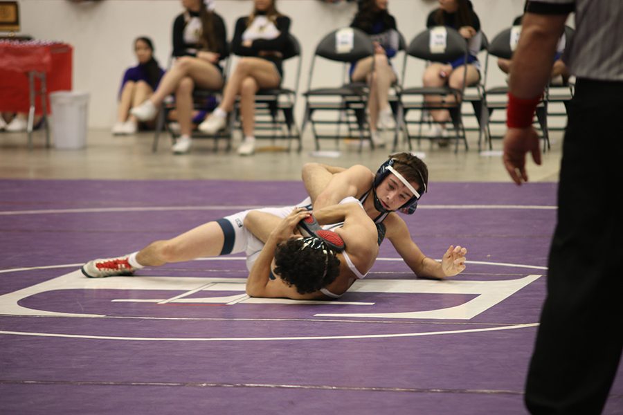 Senior Dylan Gowin gets tied up with his opponent during his match. 