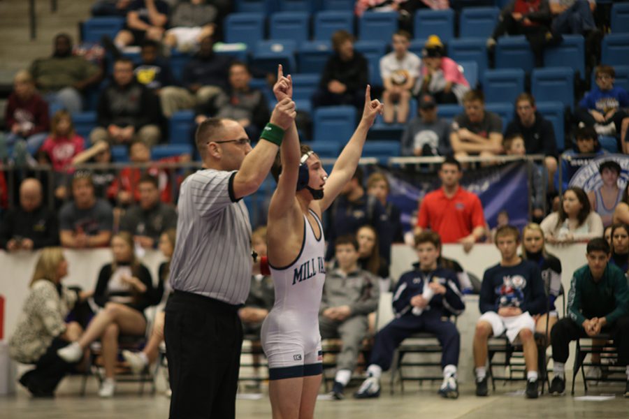 Senior Dylan Gowin turns to the crowd and holds up a one after becoming state champion. 