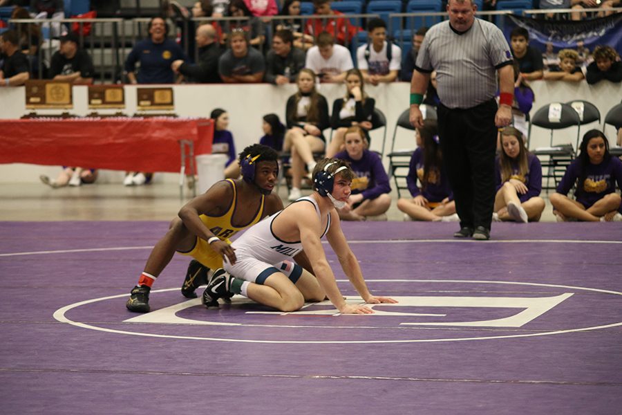 Junior Conner Ward sets up to wrestle during his finals match.