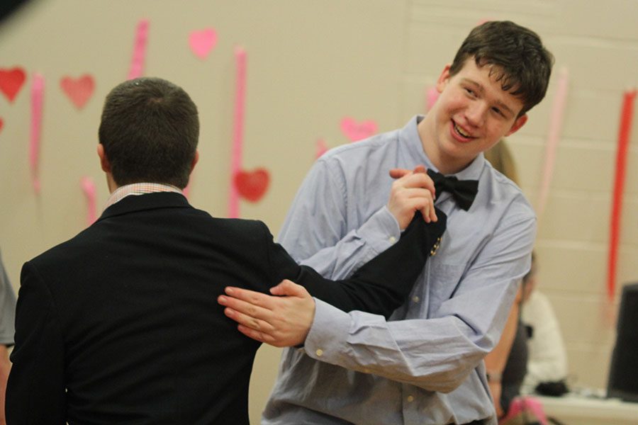 After dancing, freshman Ethan Males pats sophomore Matt Santaularia on the back.