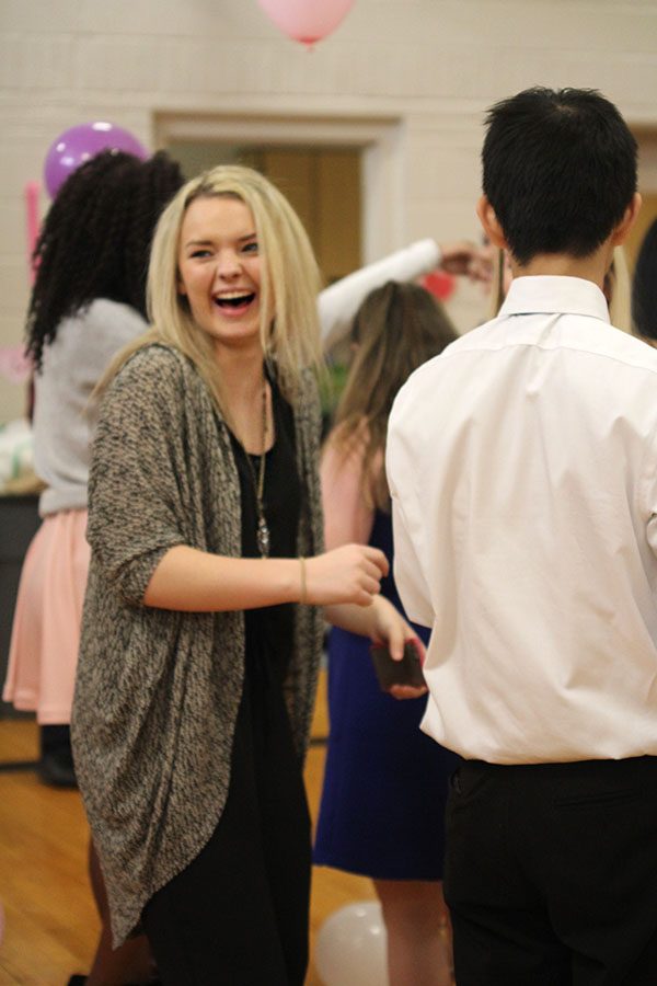 Standing in a dance circle, junior Emmy Bidnick laughs.
