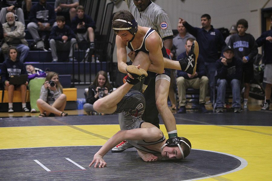 Senior Dylan Gowin holds his opponent by the leg. 