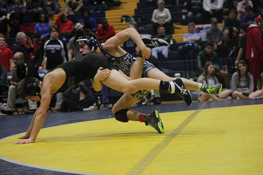 Junior Bryson Markovich takes down his opponent during his match. 
