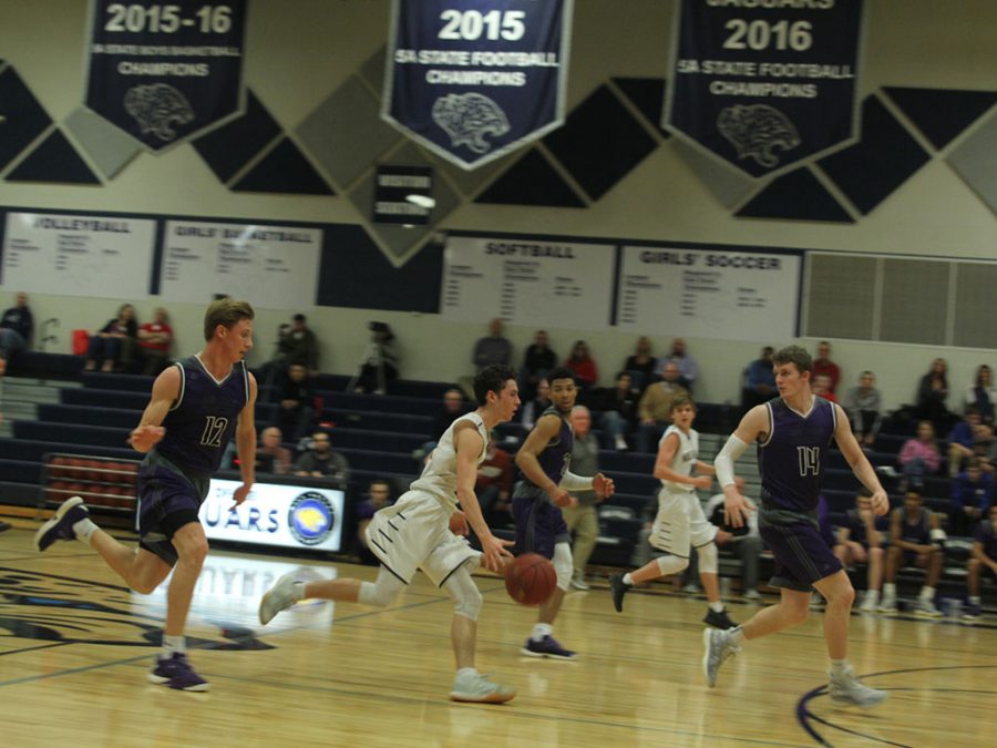 Senior Blake Montgomery dribbles across the court.