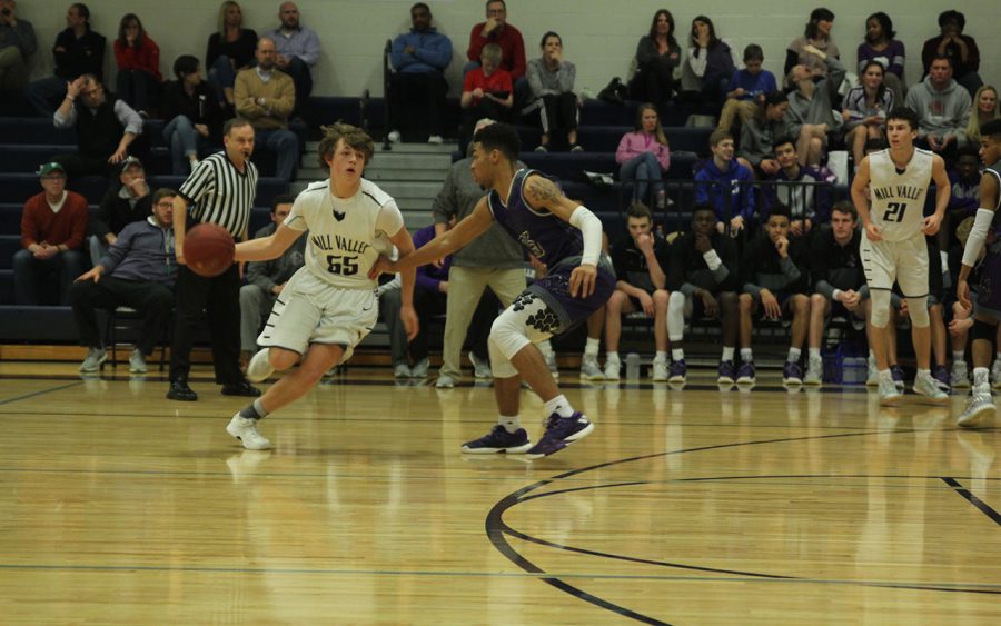 Sophomore Tanner Moore dribbles past his opponent.  