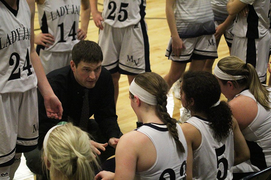 During a timeout, head coach Drew Walters talks to his team.