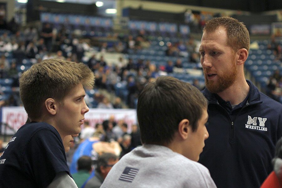Junior Jarrett Bendure discusses the outcome of a match with coach Andrew Hudgins.