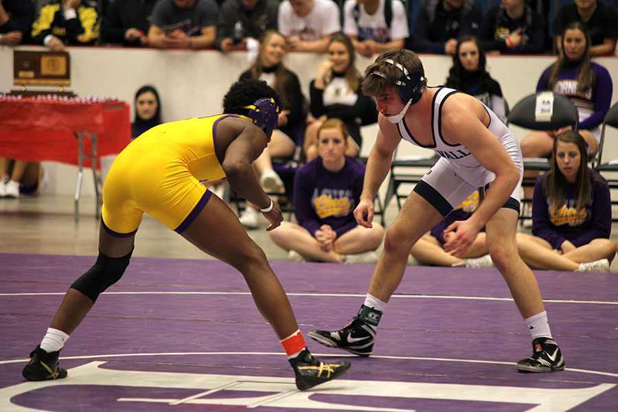 Junior Conner Ward prepares to advance towards his opponent during finals at the 5A state wrestling tournament on Saturday, Feb. 25.