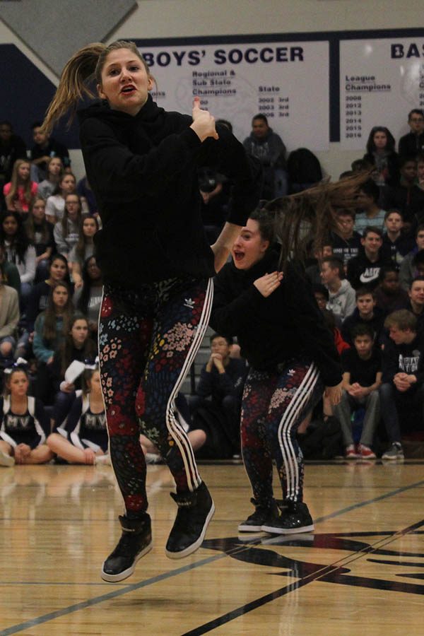 Sophomore Addie Ward jumps as a part of the Silver Stars dance routine.