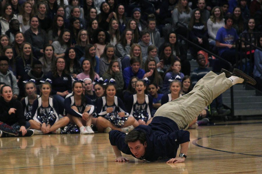 Diving onto the floor, winter homecoming candidate Ross Acre prepares to do the worm.