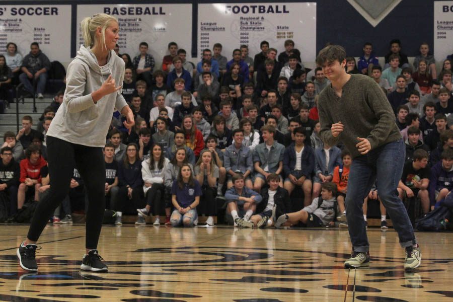 Winter homecoming candidates Courtney Carlson and Dalton Bray shimmy towards each other as they are introduced to the student body.