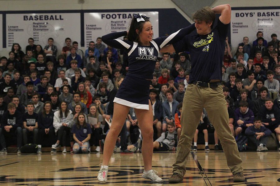 As they are introduced, winter homecoming candidates Haley Pultz and Chris Weber perform a handshake.