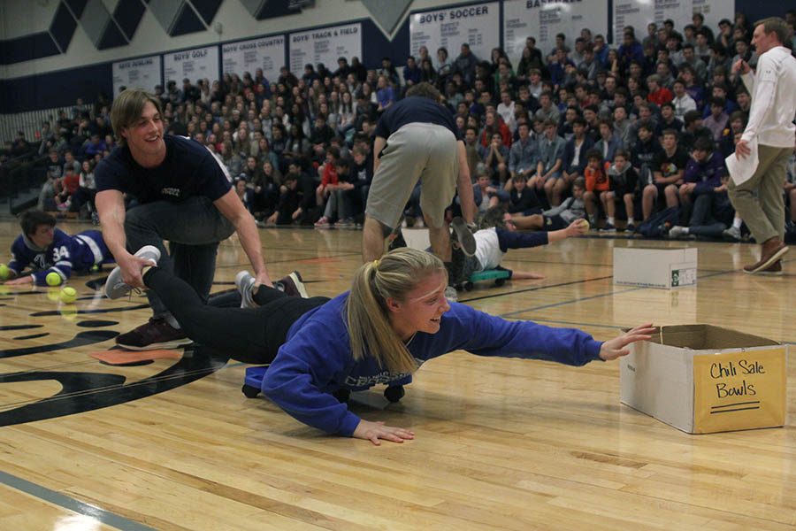 Winter homecoming candidates Kasey Meeks and Garrison Fangman race to catch as many balls as they can while playing Human Hungry Hungry Hippos.