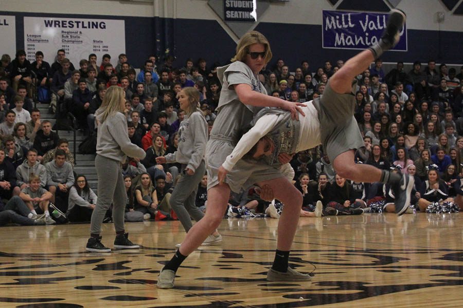 As a part of their routine, sophomore Killian OBrien assists sophomore Jack Matchette with his jump.