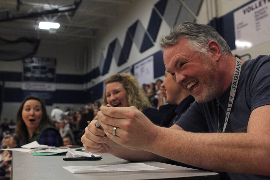 While watching the freshmen perform their dance, science teacher Chad Brown laughs alongside the other judges.