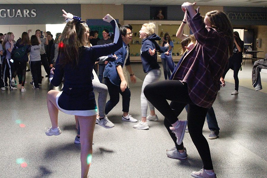 While dancing to the popular song Juju on That Beat, sophomore Ashton Rider and junior Izzy Hellon hold their arms up.