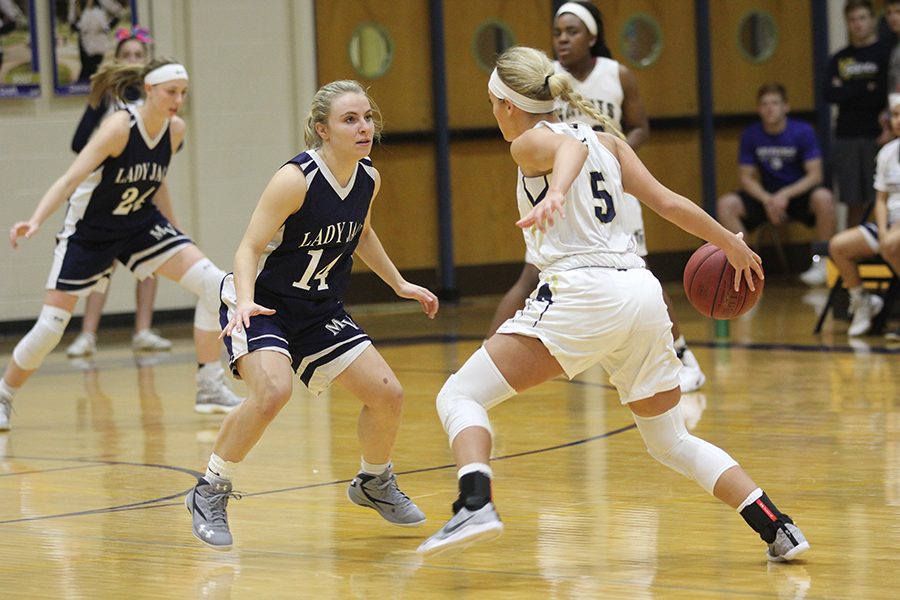 On Friday, Feb. 10, the Lady Jags lose an away game to St. Thomas Aquinas 36-52. During the first quarter, junior Adde Hinkle guards her opponent.
