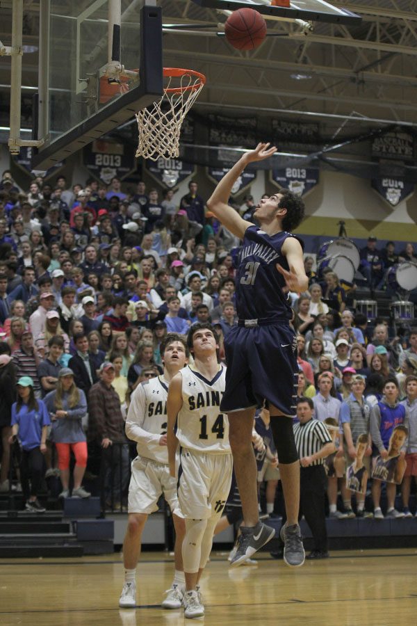 After grabbing the ball, senior Darius McLemore goes for a basket.