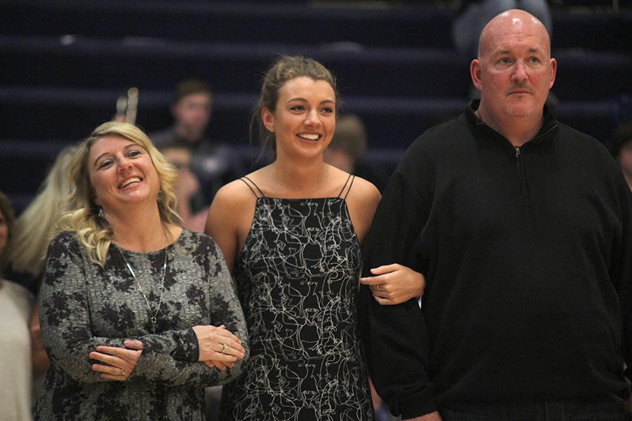 While walking with her parents, senior Kasey Blair walks down the court. 
