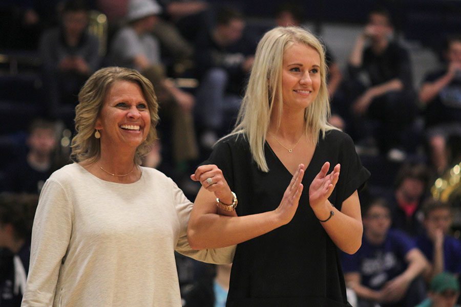 While cheering for king candidate senior Dalton Bray, senior Courtney Carlson claps.