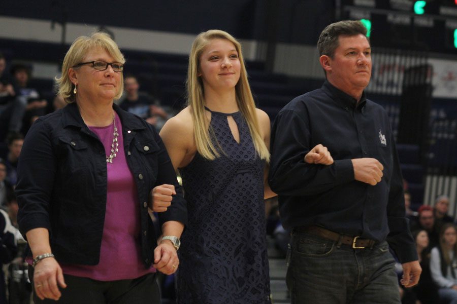 Arm-in-arm, science teacher Betsy Meeks helps escort her daughter former student Kasey Meeks across the main gym Friday, Feb. 3, 2017.