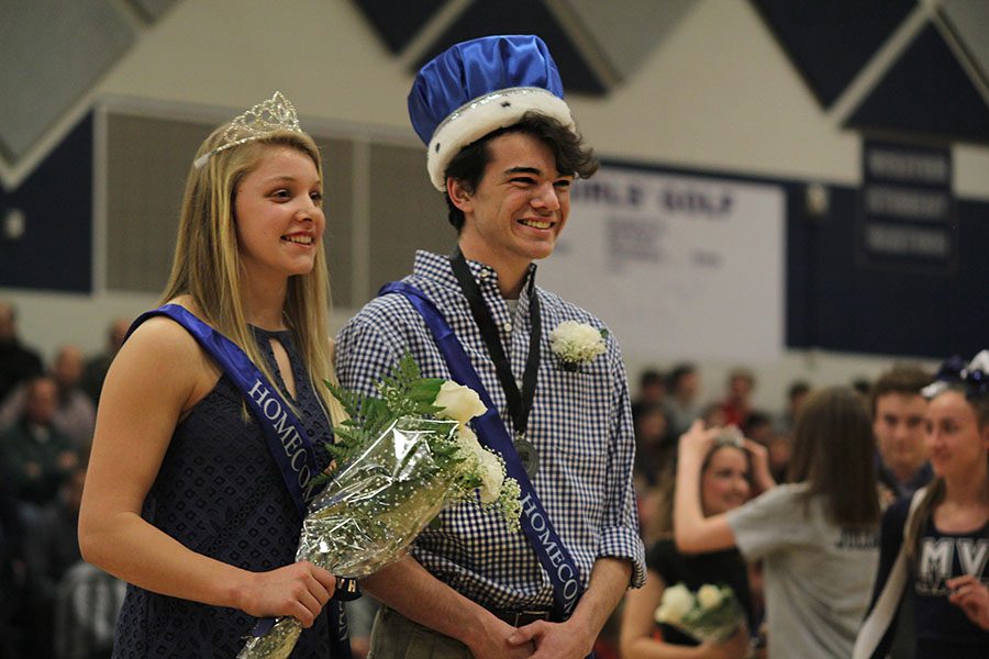 After being crowned winter homecoming queen and king, seniors Kasey Meeks and Sam Brown stand together while people cheer on Friday, Feb. 3. 
