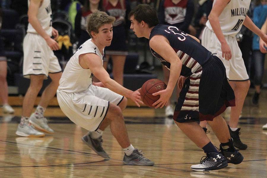 While playing defense, sophomore Logan talley attempts to steal the ball from a St. James player.