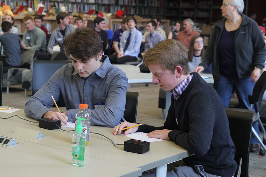 Attempting to win the round, senior Ben Stadler and junior Landon Butler work out a problem.