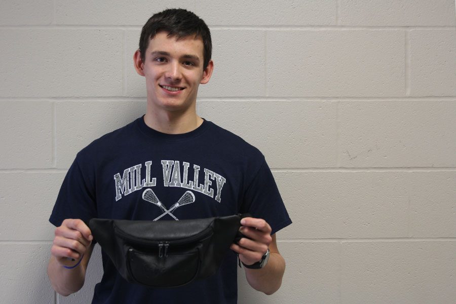 Freshman Mason Ericson holds up his well-known fanny pack that he wears every single Friday on Friday, Feb. 24.