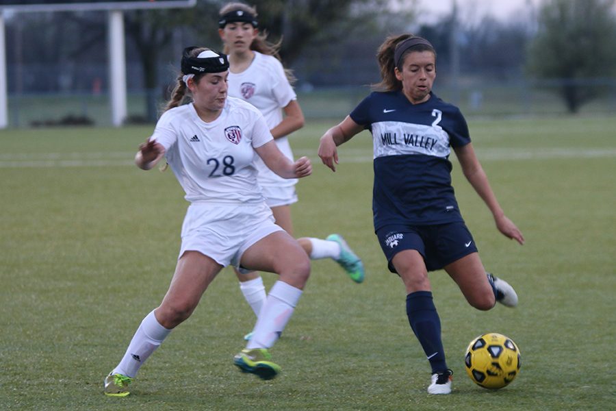 Senior Haley Freeman prepares to kick the ball away from her opponent.