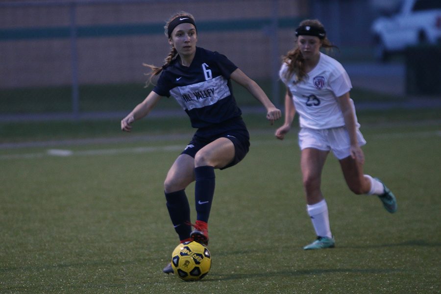 Freshman Emerson Kaiser dribbles the ball past her opponent.