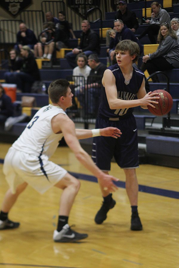 Guarding the ball, senior Jack Cooper looks for a player to pass to.