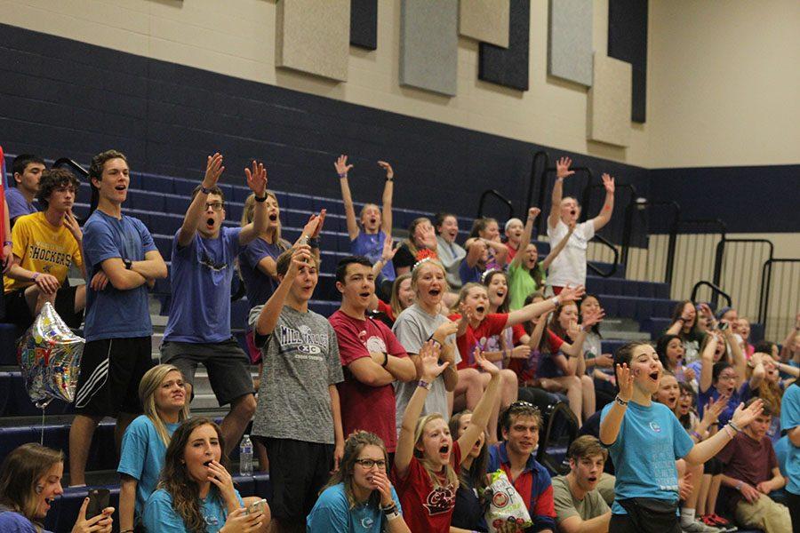Students cheer for jump the creek participant. 