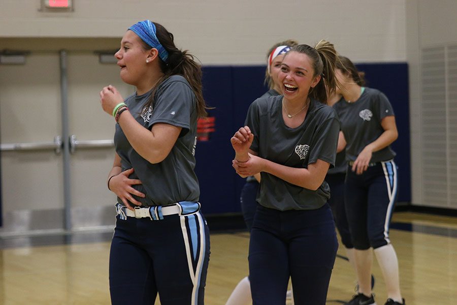 At the annual Kick Butts volleyball tournament, freshman Lauren Florez and sophomore Kaitlin Lutz laugh after a play on Wednesday, March 22.