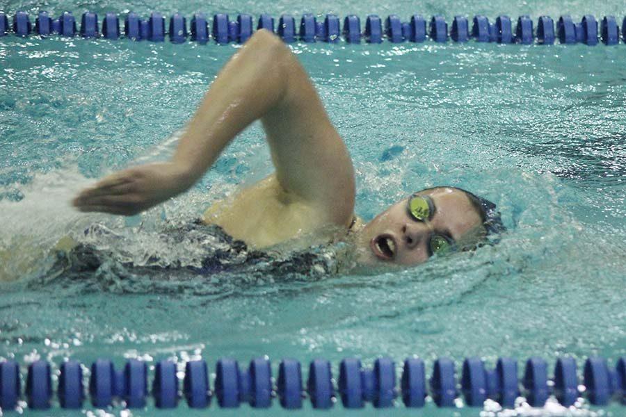 Senior Vicki Robinson brings her arm over her head while completing her freestyle stroke.