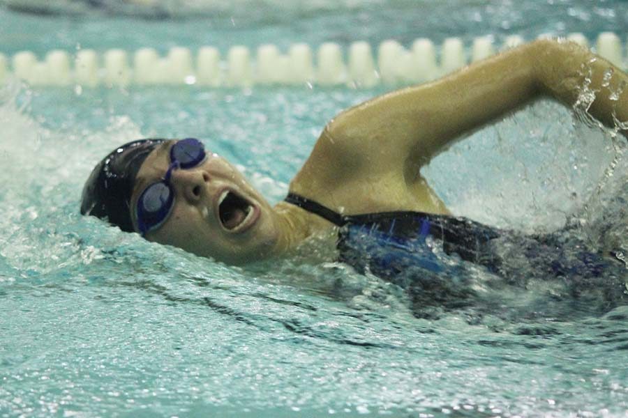 Junior Jordan Robinson turns to the side for a breath of air while swimming freestyle.