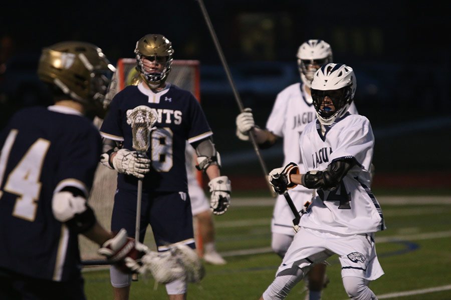 Sophomore Jake Fiscella, faces off with oposing teammate on Tuesday, March 28. The varsity team lost 6-5 against Aquinas.