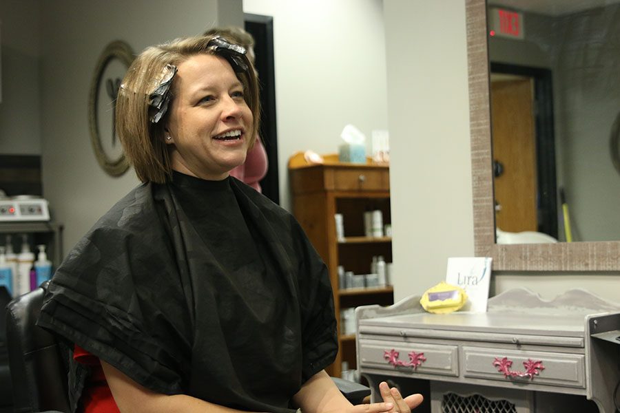 Agre sits and waits while dying her hair.