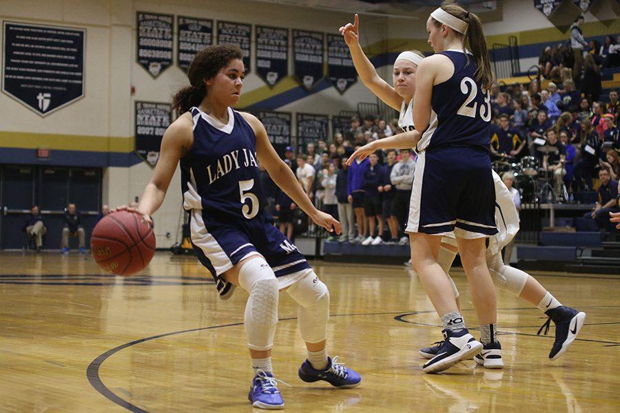 As sophomore Claire Kaifes guards her opponent, sophomore Presley Barton dribbles the ball. 