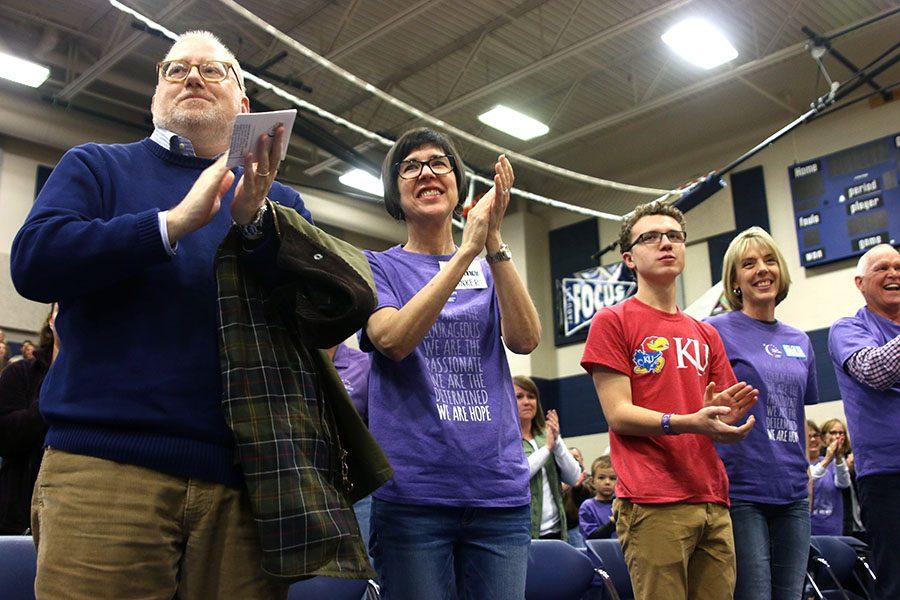Several survivors and community members, including junior Zach King, stand to applaud Relay for Life committee members at the event on Friday, March 31.