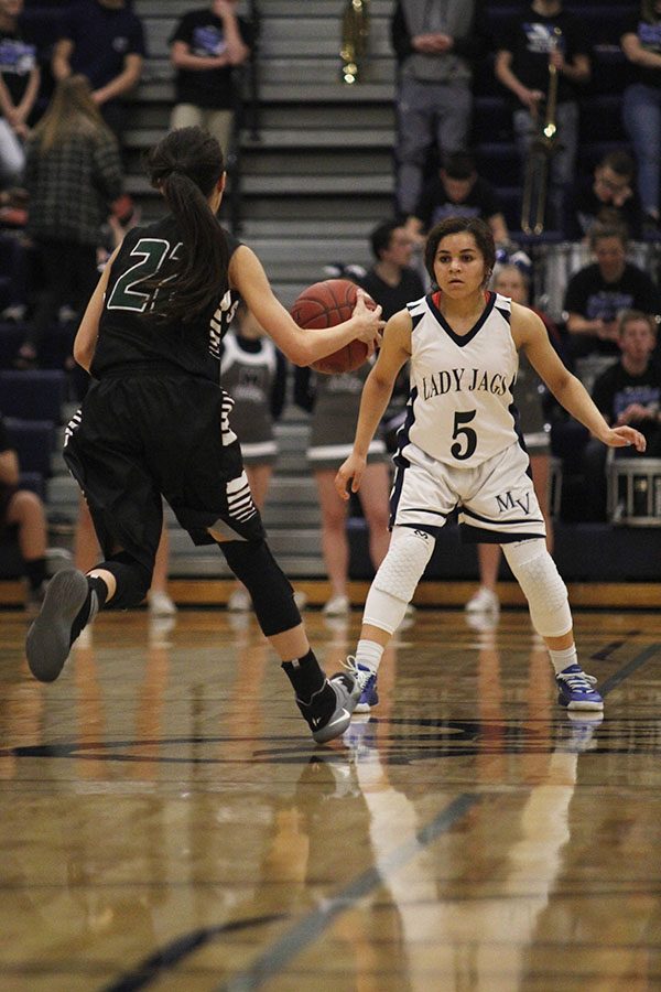 Playing defensively, sophomore Presley Barton blocks an opponent.
