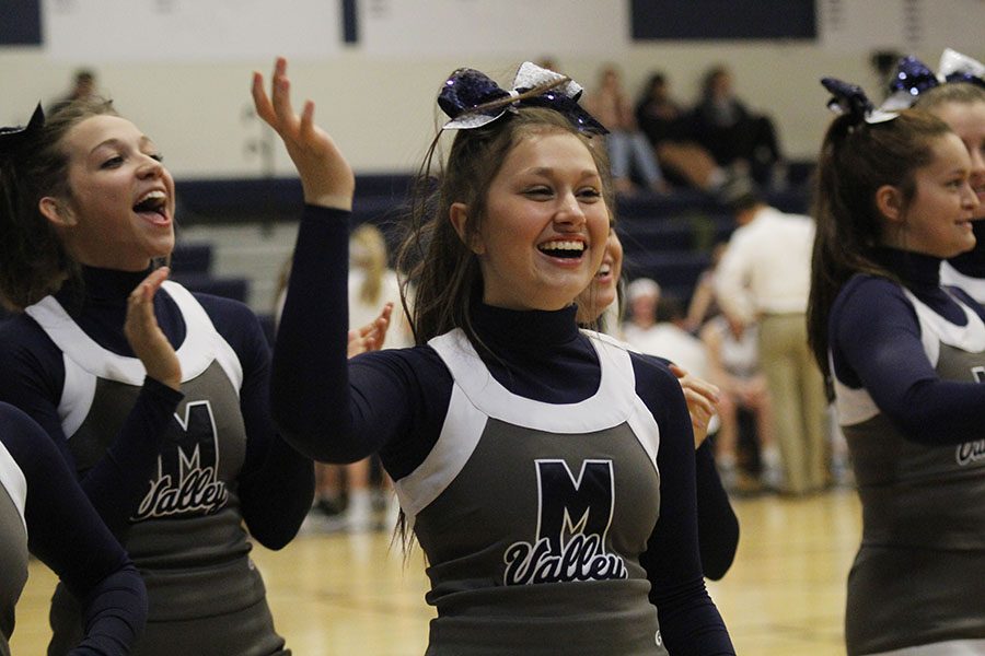 Between third and fourth quarter, sophomore Ashton Rider cheers with the team.