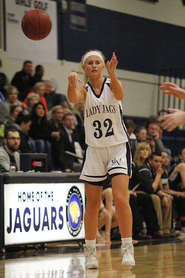 After finding a teammate, senior Courtney Carlson passes the ball.
