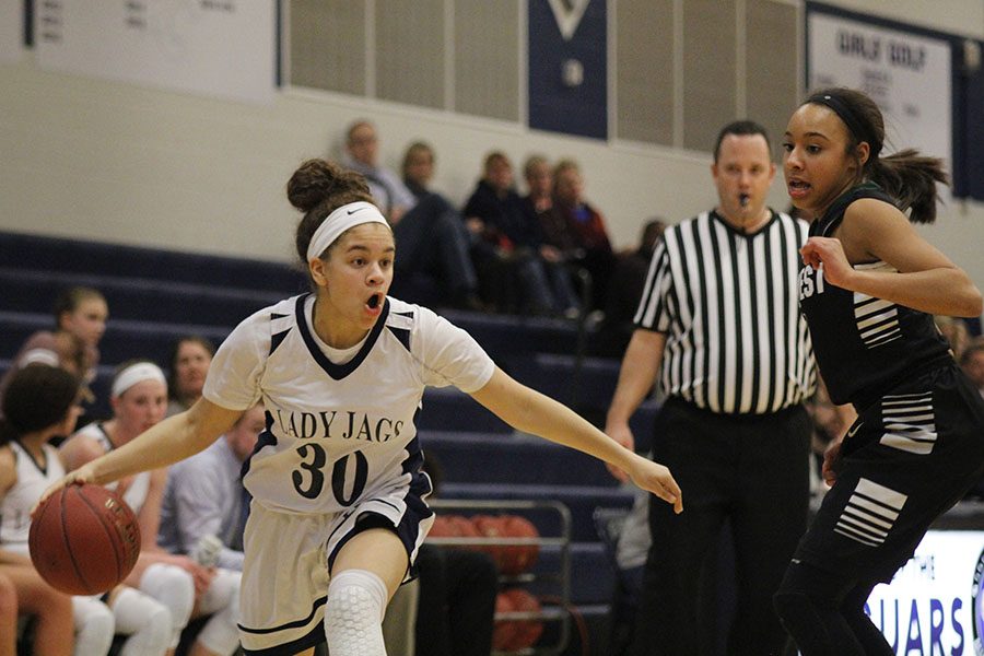 Headed toward the basket, senior Elena Artis dribbles the ball.