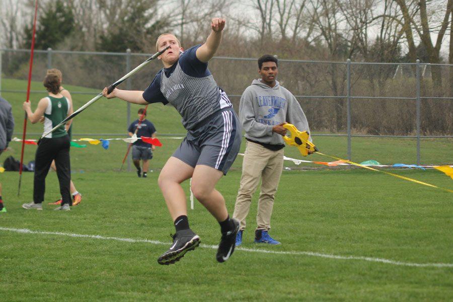 Pulling his arm back, junior Jacob Broadbent prepares to launch the javelin on Tuesday, March 28 at De Soto.