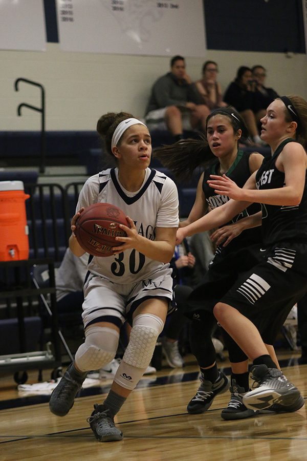 Senior Elena Artis dodges opponents while trying to pass the ball.