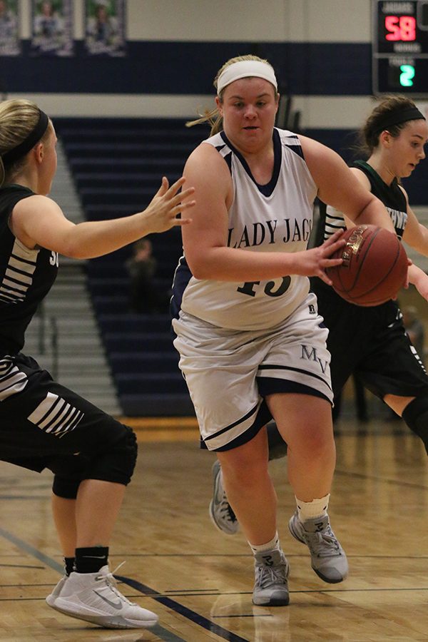 Senior Ashlyn Hendrix prepares to dribble down the court.