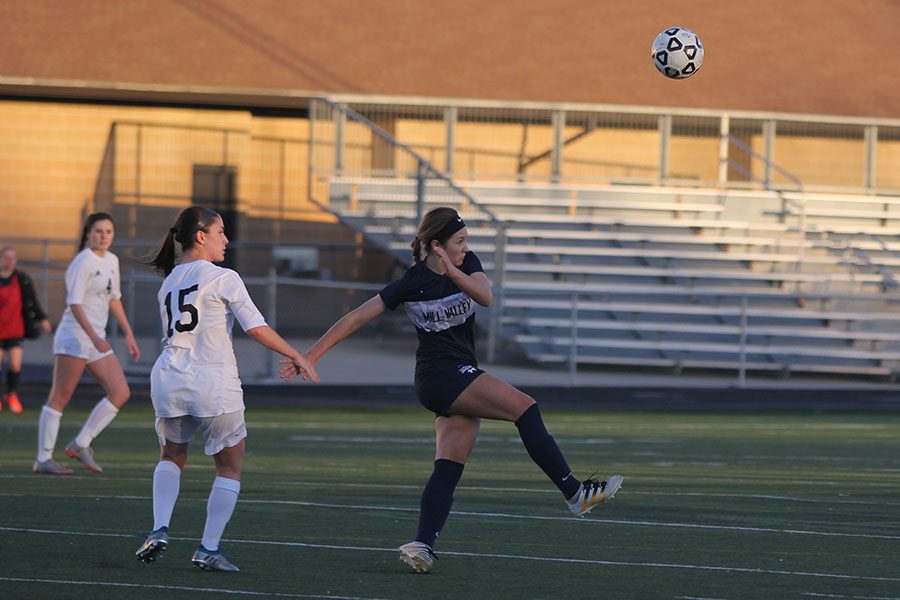 Freshman Ella Shurley bends back as the ball leaps in the air.