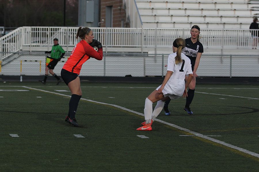 As sophomore Grace Goetsch catches the ball, sophomore Ally Klaudt stays close by.